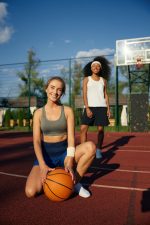 Cute multicultural female basketball player taking rest